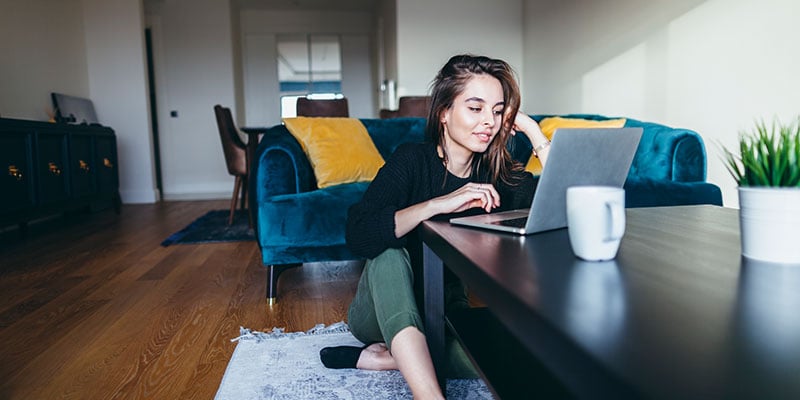 Young woman on computer in living room 